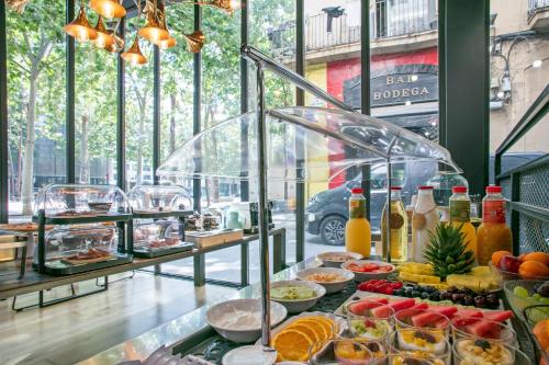 a buffet with a lot of food on display at Niu Barcelona Hotel in Barcelona