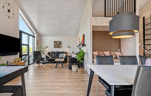 a living room with a table and chairs at Gorgeous Home In Haderslev in Haderslev