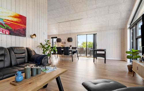 a living room with a couch and a table at Gorgeous Home In Haderslev in Haderslev