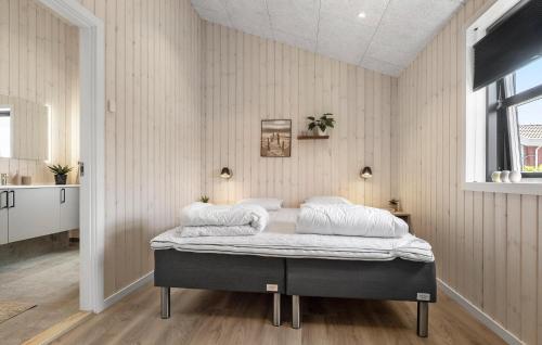 a bedroom with a bed with two pillows on it at Gorgeous Home In Haderslev in Haderslev