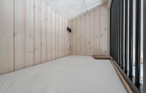 an empty room with wood paneled walls and a ceiling at Gorgeous Home In Haderslev in Haderslev