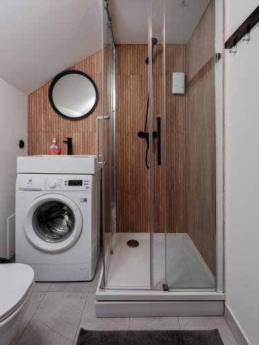 a bathroom with a washing machine and a washer at Colonel Suites & Apartments in Riga