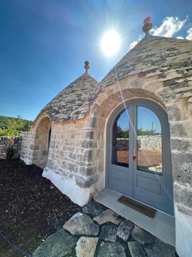 an entrance to a stone building with a door at Masseria Mazzalorsa in Alberobello