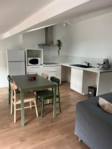 une cuisine et une salle à manger avec une table et des chaises dans l'établissement Appartement hyper centre-ville, à Vaison-la-Romaine