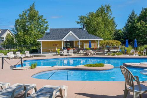 a swimming pool with chairs and a house at Beautiful & Bright 3 Bed Townhome Near Village in Blue Mountains