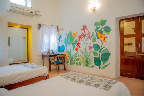a room with two beds and a painting on the wall at Aloof Jungle Lodge in Ghānerao