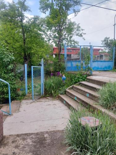 a set of stairs in a park with a gate at Ojakh in Dilijan