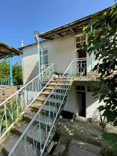 a building with a staircase in front of a building at Ojakh in Dilijan