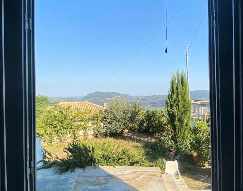 a view of a yard from a window at Ληγάτο Cottage House in Áyios Pétros