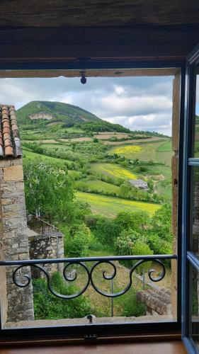 a window with a view of a green field at Gîte de la Murette in Compeyre