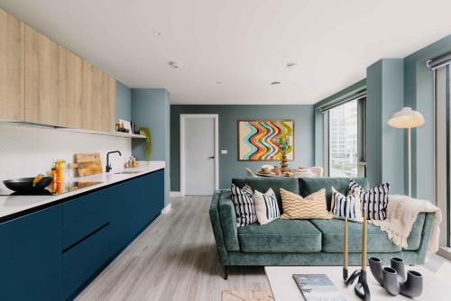 a kitchen and living room with a green couch at Charles Hope Birmingham Westside in Birmingham