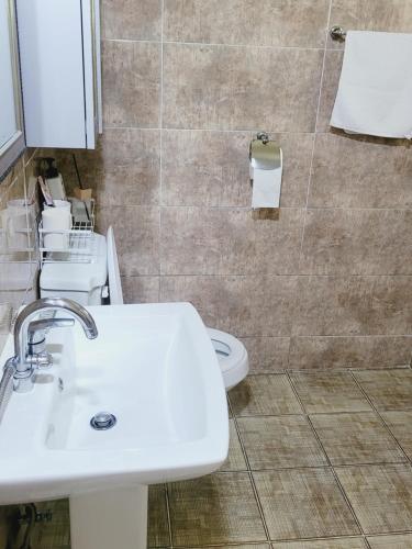 a bathroom with two sinks and a toilet at Gyeongju Moon Rabbit in Gyeongju