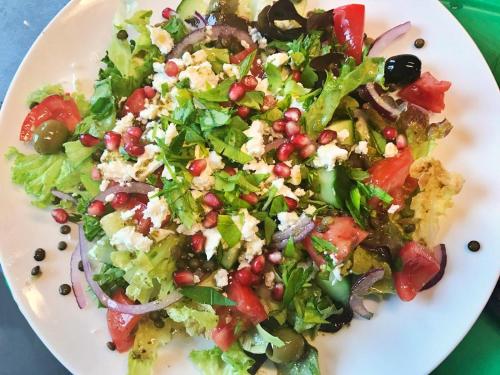 a salad on a white plate on a table at Patio des Rêves - Charme au cœur du Gers in Aujan-Mournède
