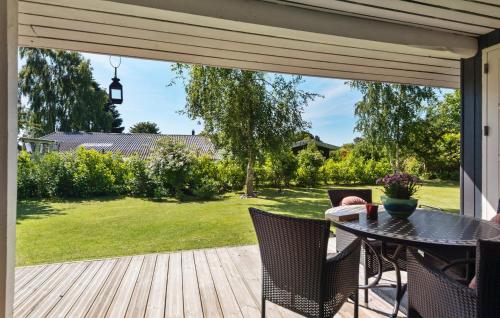 a patio with a table and chairs on a deck at 3 Bedroom Nice Home In Odder in Beder