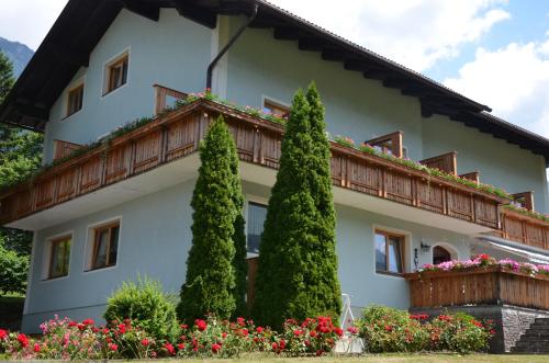 a large white house with a balcony at Landhaus Königsreiner in Kolbnitz