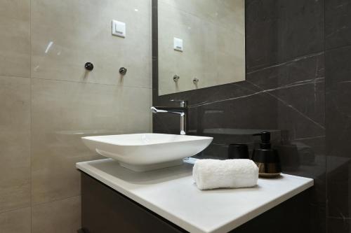 a bathroom with a white sink and a mirror at Cloud 9 D10 in Tkon