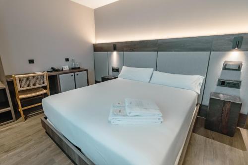 a large white bed in a small room at HOTEL RURAL FINCA LA DESA in Miajadas