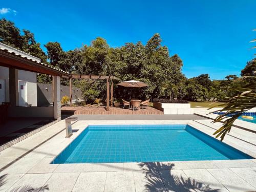 a swimming pool in the middle of a yard at Wakanda House Casa de veraneio in Magé