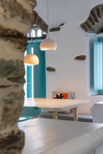 a table in a room with blue walls at Melina house Platia Tinos in Platiá