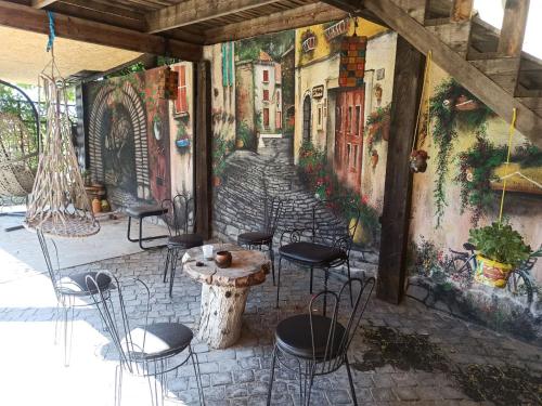 a room with chairs and a table and a mural at Загородный дом in Nurrnus