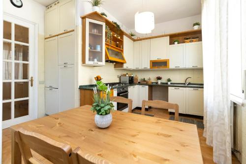 a kitchen with a wooden table with a vase of flowers on it at casa a colori in Ancona