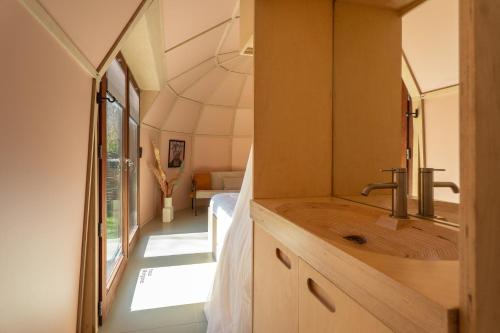 a bathroom with a wooden sink in a room at Cabin Fata Morgana in Kats