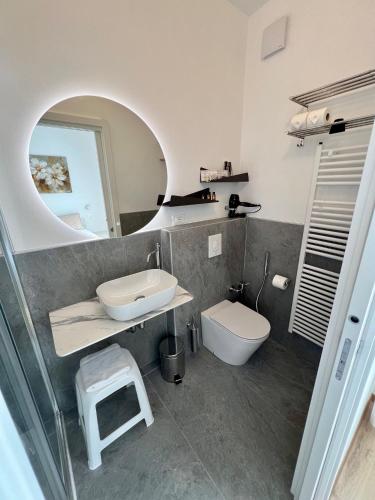 a bathroom with a sink and a toilet at Cecia's House in Bassano del Grappa