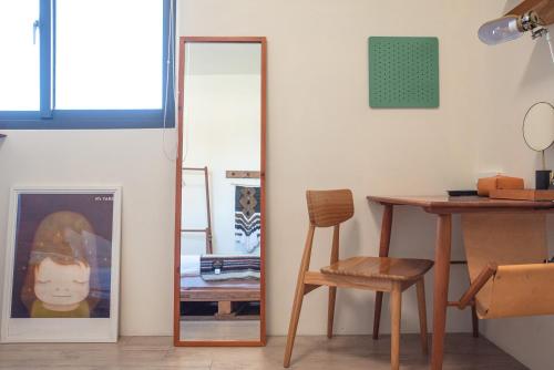 a room with a table and a mirror and a chair at Boy apartment -Adult only in Hualien City