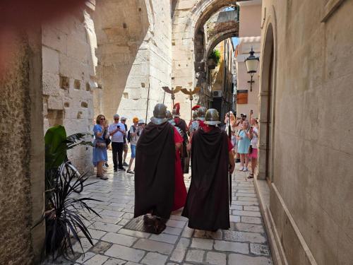 a group of nuns walking down a street at Malena Palace Experience in Split