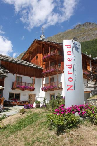 a building with a sign in front of it at Hotel Nordend in Gressoney-la-Trinité