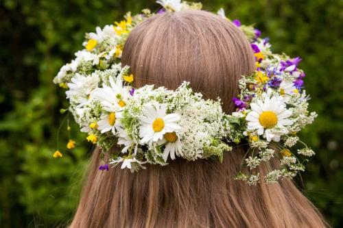 a woman with a flower crown on her head at Cozy room surrounded by nature in Falun