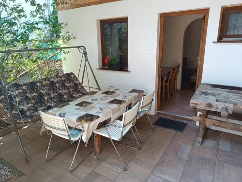 a patio with a table and chairs and a couch at Dóra Apartman in Balatonszárszó