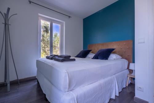 une chambre avec un grand lit blanc avec des murs bleus dans l'établissement Villa Serenity, à Nice