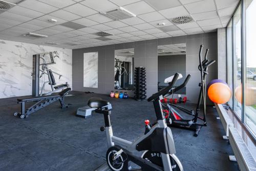 a gym with two exercise bikes in a room at Porta Mare Apartament Bajka in Dziwnów