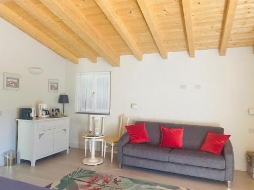 a living room with a couch and red pillows at La Cabana Cinque Terre Monterosso in Monterosso al Mare