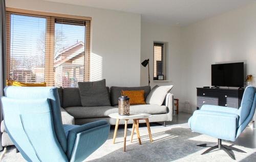 a living room with a couch and chairs and a tv at Stunning Home In Idskenhuizen - With Wifi in Idskenhuizen