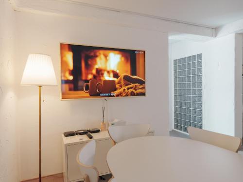 a living room with a fireplace on the wall at SeogyoHueStay in Seoul