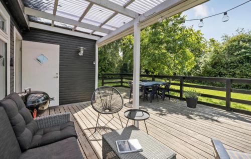 a patio with a couch and a table on a deck at 2 Bedroom Gorgeous Home In Holbæk in Holbæk