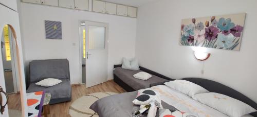 a small bedroom with a bed and a mirror at APP Tilia in Crikvenica