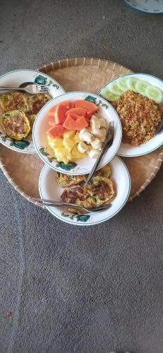 a table with three plates of food on it at Ananda Bungalow Tetebatu in Tetebatu