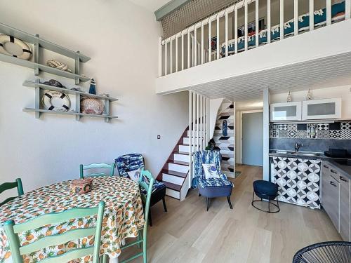 une chambre avec une table, des chaises et un escalier dans l'établissement Appartement à Saint-Cyr-sur-Mer proche plage avec clim et parking privé - FR-1-770-45, à Saint-Cyr-sur-Mer