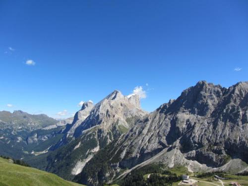 a view of a mountain range with a blue sky at Hotel Wieslhof in Collepietra