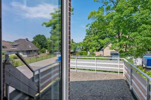 a sliding glass door with a view of a fence at Ferienhaus Neumann in Heide