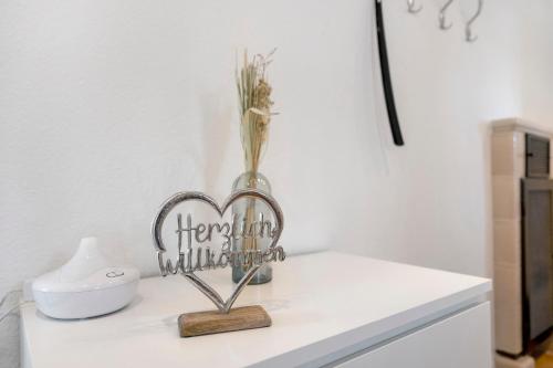 a heart shaped sign sitting on top of a counter at Ferienhaus Neumann in Heide