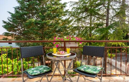 a table and two chairs on a balcony at 1 Bedroom Nice Apartment In Pinezici in Pinezici