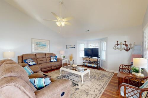 a living room with a couch and a tv at Pops Place in Atlantic Beach