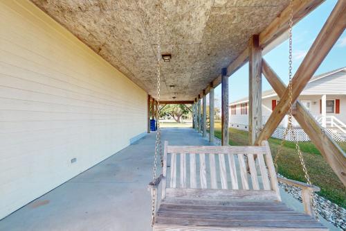 a porch swing hanging from the side of a building at Pops Place in Atlantic Beach