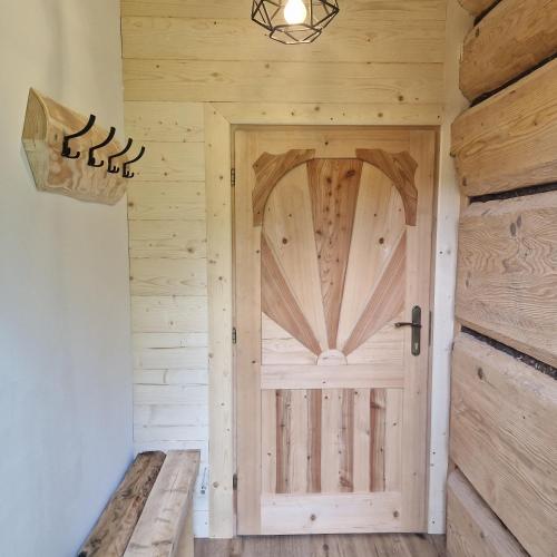 a wooden door in a room with a wall at CICHY ZAKĄTEK - noclegi blisko Termy Chochołowskie in Ciche
