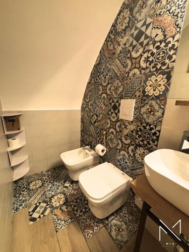 a bathroom with two toilets and a sink at Mia - Molfetta Inn Apartments in Molfetta