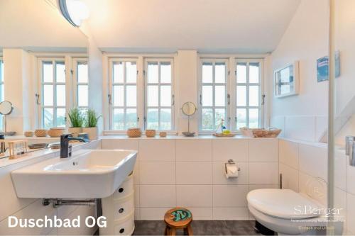 une salle de bain avec un lavabo et des toilettes dans l'établissement Wattkieker, à Utersum